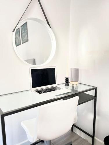 a desk with a laptop and a mirror at New Studio Apt Central》Private》 Free Parking》WiFi in Stockport