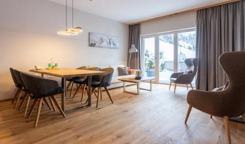 a living room with a dining room table and chairs at Hotel Residenz Hochalm - Joker Card Partner in Saalbach Hinterglemm