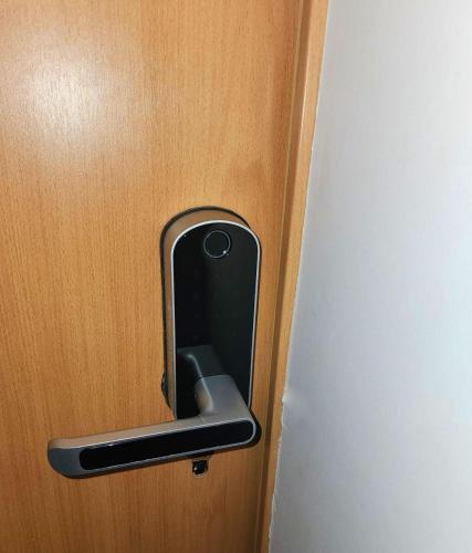 a metal door handle on a wooden door at Modern Apartment - Work from Zanzibar (Fumba Town) in Dambani