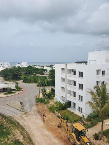 a building on a dirt road next to a building at Modern Apartment - Work from Zanzibar (Fumba Town) in Dambani