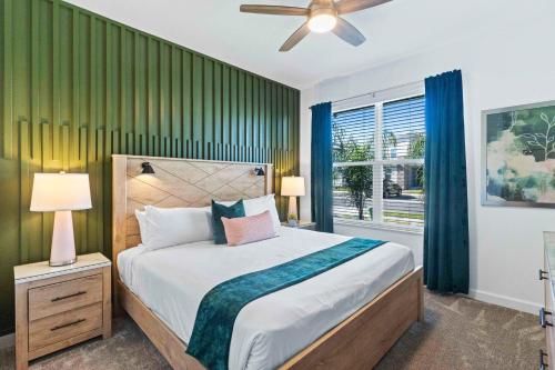 a bedroom with a large bed and a window at 9203 Sommerset Hills Drive in Kissimmee