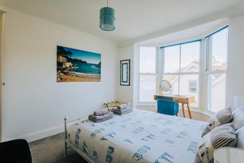 a bedroom with a bed and a desk and a window at The Slipway Fowey Harbour Parking 1 Min & Garden in Fowey