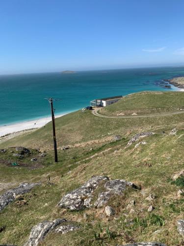 a pole on top of a hill near the ocean at Loch an Eilean Pod Isle of South Uist in Pollachar
