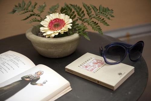a table with a book and a pair of glasses at Hotel S. Anna in Rome