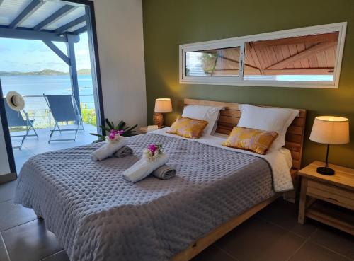 a bedroom with a large bed with flowers on it at EAST KEYS - Lucy's Bay in Hyacinthe