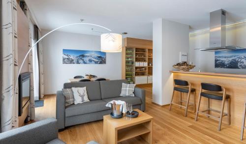 a living room with a couch and a table at Hotel Residenz Hochalm - Joker Card Partner in Saalbach Hinterglemm