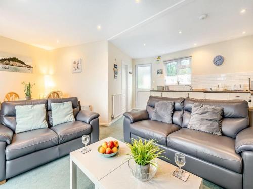 a living room with two couches and a table at Beach View - Mount Brioni in Downderry