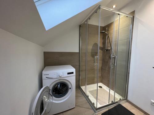 a washing machine in a bathroom with a glass shower at Laineckerstrasse 8 in 95445 Bayreuth in Bayreuth