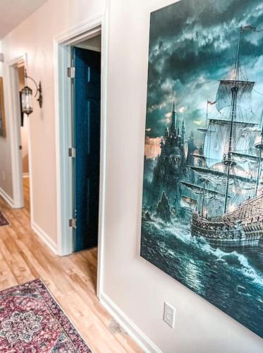 a painting of a ship on a wall at Bombastic Home - Steps to Beach - GameRm - Hot Tub - Pet Friendly in Surf City