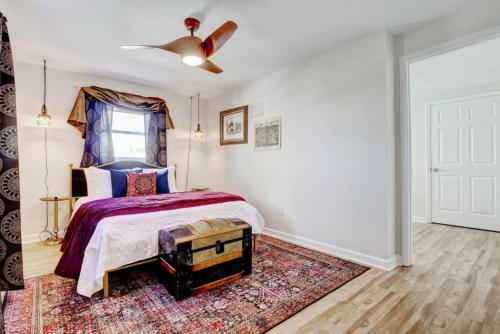 a bedroom with a bed and a ceiling fan at Bombastic Home - Steps to Beach - GameRm - Hot Tub - Pet Friendly in Surf City