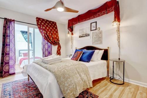a bedroom with a bed with a red canopy at Bombastic Home - Steps to Beach - GameRm - Hot Tub - Pet Friendly in Surf City