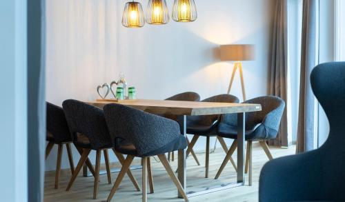a dining room with a table and chairs at Hotel Residenz Hochalm - Joker Card Partner in Saalbach Hinterglemm