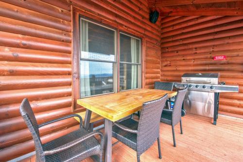 a wooden table and chairs on the porch of a cabin at Hawk's View Log Cabin in Lake Lure