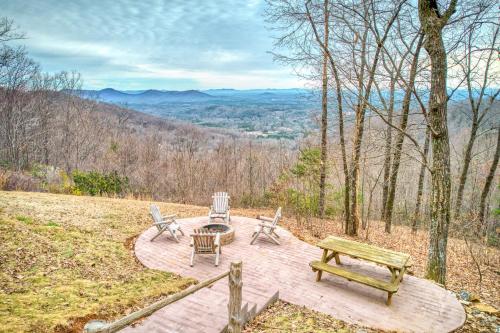 a patio with a bench and a table and chairs at Hawk's View Log Cabin in Lake Lure