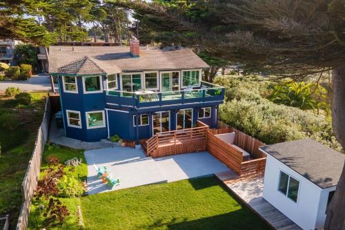 an aerial view of a blue house at Oceanfront Home Retreat w Breathtaking Views of Fitzgerald Marine Reserve in Moss Beach