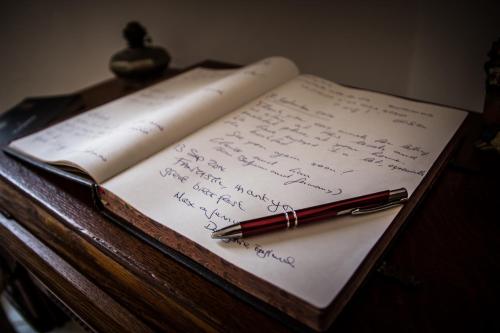 a pen sitting on top of an open book at Dimora Antonella - Ostuni 4 seasons - Splendid Villa Depandance with Private Swimming Pool in Ostuni