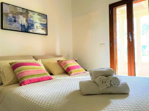 a bedroom with a bed with two pillows on it at Dimora Antonella - Ostuni 4 seasons - Splendid Villa Depandance with Private Swimming Pool in Ostuni