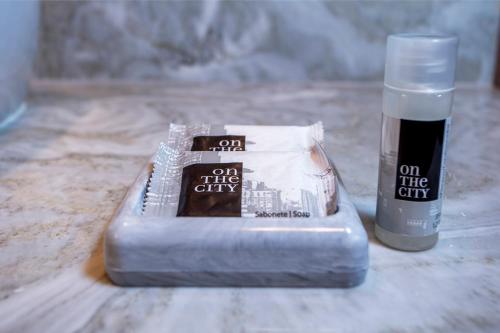 a container of on the city products sitting on a counter at Hotel Praia do Portinho in Ilhabela