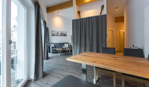 a dining room with a table and a large window at Hotel Residenz Hochalm - Joker Card Partner in Saalbach Hinterglemm
