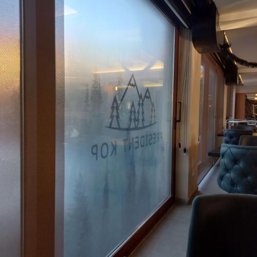 a glass window with a sign on the side of a room at President KOP A515 in Kopaonik