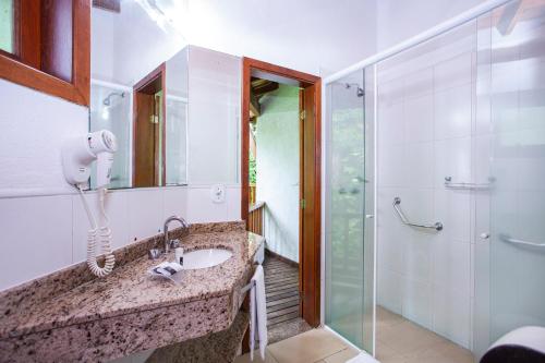 a bathroom with a sink and a shower at Hotel Praia do Portinho in Ilhabela