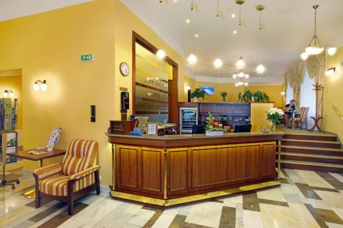 a lobby with a counter and a waiting room at Ensana Svoboda in Mariánské Lázně