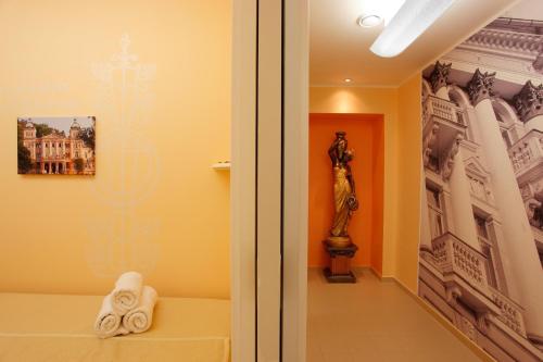 una habitación con una cama y una estatua de una mujer en Ensana Svoboda en Mariánské Lázně