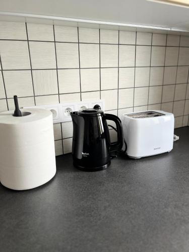 a coffee pot and a toaster on a kitchen counter at Apartment Golden Prague 78 in Vestec