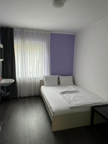a bedroom with a white bed and a window at Hotel Annis M&P in Dortmund