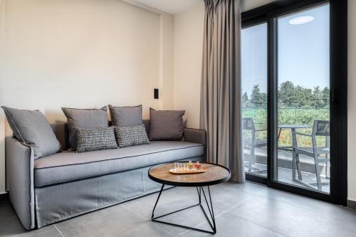 a living room with a couch and a table at Sezian Boutique Homes and Villas in Preveza