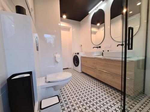 a bathroom with a toilet and a sink and mirrors at Rezydencja Green Hill - ekskluzywny dom w Karpaczu in Karpacz