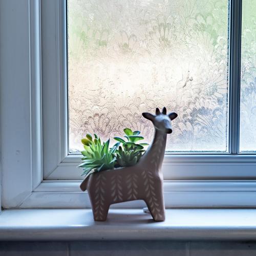 a small figurine of a deer sitting on a window sill at Springfield Place - 3 Bed Cent Reading - Long term savings - Free Parking in Reading