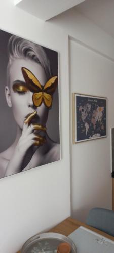 a painting of a woman with a butterfly on a wall at President KOP A515 in Kopaonik