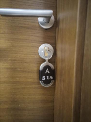 a door handle with a sign on a door at President KOP A515 in Kopaonik