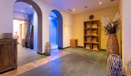 a room with three arched windows and vases at Hotel Residenz Hochalm - Joker Card Partner in Saalbach Hinterglemm