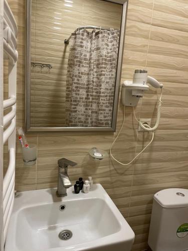 a bathroom with a sink and a toilet at Glendale Boutique Hotel in Yerevan
