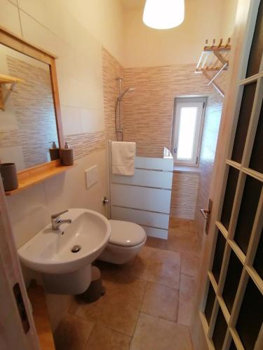 a bathroom with a white sink and a toilet at il borghetto in valle d'itria in Martina Franca