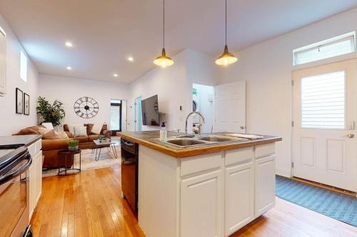 a kitchen with a sink and a living room at Private Home-Backyard-Parking Near Nulu Downtown in Louisville