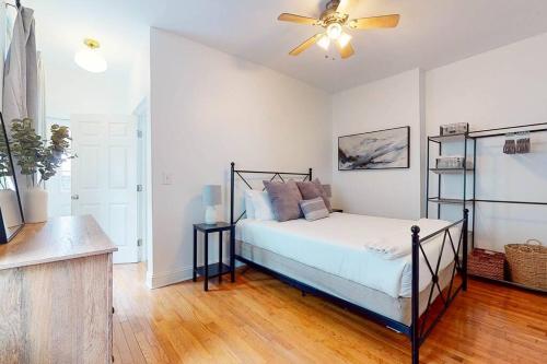 a bedroom with a bed and a ceiling fan at Private Home-Backyard-Parking Near Nulu Downtown in Louisville