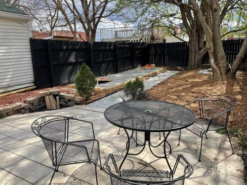 a patio with a table and chairs on a sidewalk at Private Home-Backyard-Parking Near Nulu Downtown in Louisville