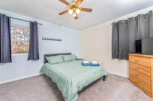 a bedroom with a bed and a ceiling fan at Reilly Road Refuge in Fort Bragg