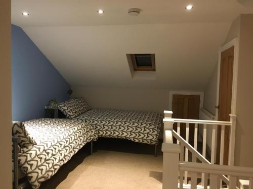 a bedroom with a bed in a attic at NEW Derby Pride Park Arena Moorways 4 bedrooms 7 beds -Spacious contractors or group -FREE PARKING in Derby