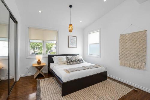 a white bedroom with a bed and a window at Stunning TH #5 in Los Angeles