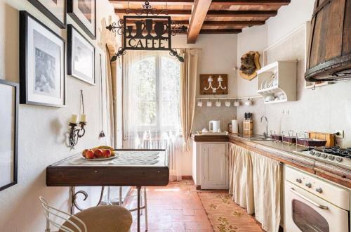 a kitchen with a counter and a sink and a window at Villa San Filippo in Arezzo