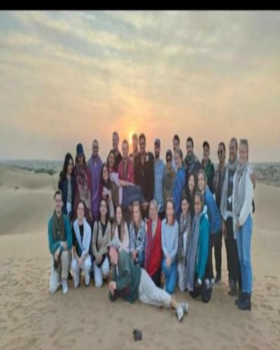 a group of people posing for a picture on the beach at Naman Haveli-Boutique Stay For Budget Travllers in Jaisalmer