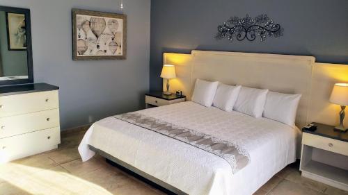 a bedroom with a large bed with white sheets and pillows at Combate Beach Resort in Cabo Rojo