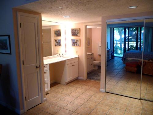 a bathroom with a sink and a mirror at Leaward Isle Island Retreat in Key West