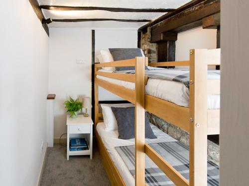 a bedroom with two bunk beds in a room at Crown Inn in Woolhope