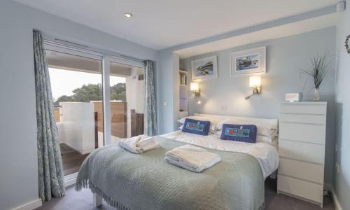 a bedroom with a bed with two pillows on it at Curlew 3 - The Cove in Brixham