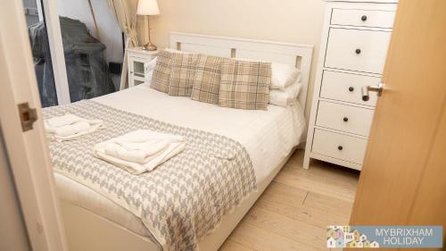a bedroom with a bed with two towels on it at Curlew 5 - The Cove in Brixham
